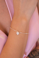 Pulseira bolinhas c/ pingente de coração cravejado